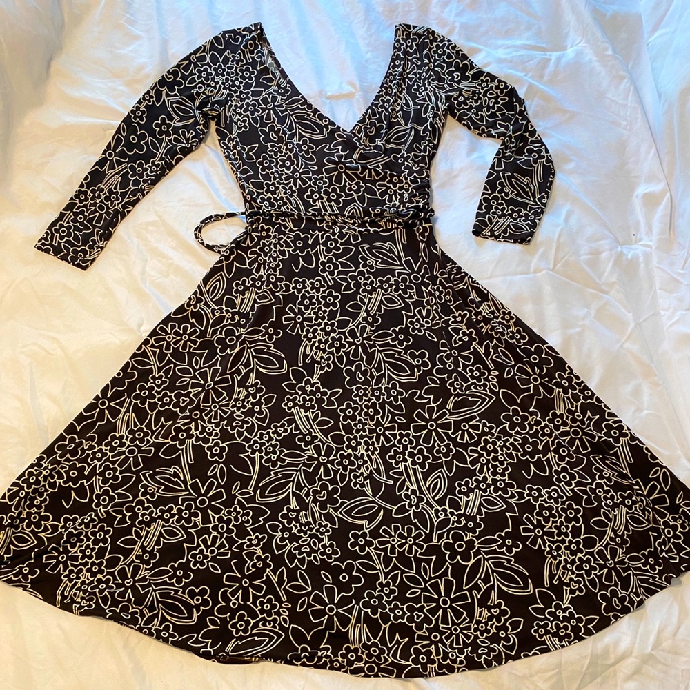 Gathered waist.looks like a wrap dress. Plunging neckline and back
